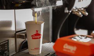 Casey's bean-to-cup coffee pouring into a cup with steam