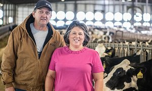 Kelly and Christy Cunningham at their Milk Unlimited farm with cows in the background