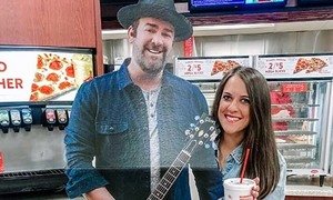 Guest taking a picture with a Lee Brice cutout in a Casey's store