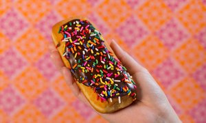 Chocolate frosted Long John donut with sprinkles